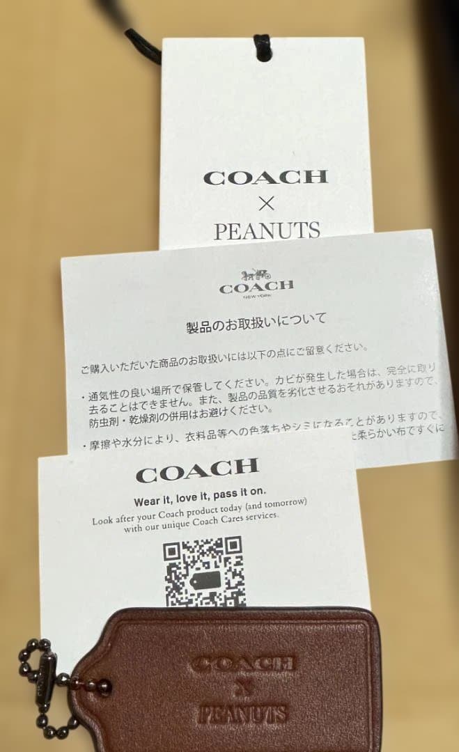 COACH X PEANUTSレーサー スリングパックシグネチャー スヌーピー